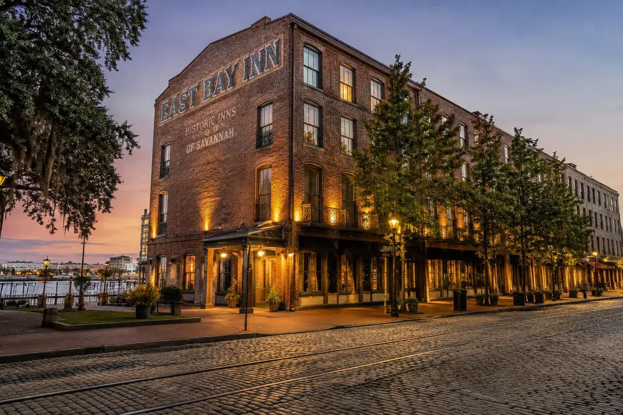 Historic East Bay Inn near Savannah's riverfront at dusk.